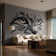 Printed wall decal of a detailed black-and-white cat face with intense eyes, applied to a smooth light wall in a modern living room with a white sofa and wood flooring. The decal is printed on transparent vinyl.