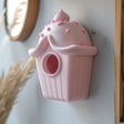 3D printed wall hanging shaped like a cupcake-style birdhouse, minimalist matte PLA decor for modern kitchen or kids room interior.