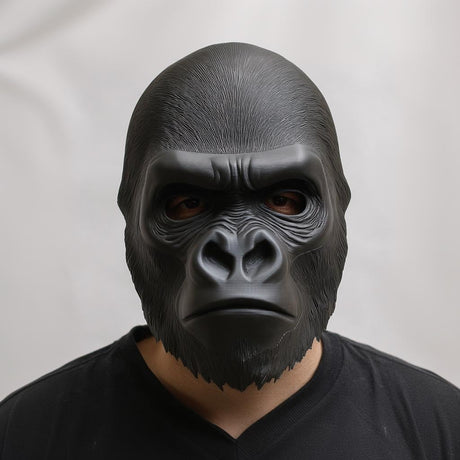 Front view of a 3D printed gorilla face mask worn by a person, showing realistic sculpted fur texture and matte black finish against a neutral background.