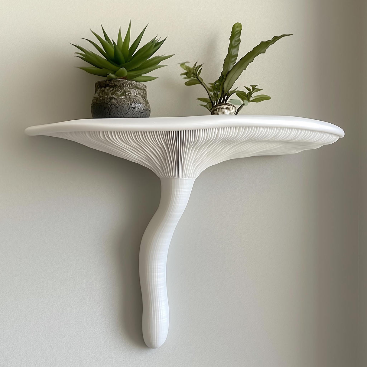 &quot;White 3D printed wall shelf in the shape of an Artist’s Conk mushroom, styled with potted plants and mounted on a light wall.&quot;