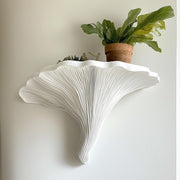 White 3D printed shelf shaped like a Turkey Tail mushroom, featuring gill-like grooves.