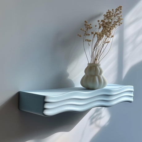 3D printed minimalist wavy wall shelf with ripple design, holding a vase, modern matte PLA texture in natural daylight
