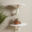 &quot;Set of two white 3D printed mushroom-inspired wall shelves with curved stems, styled with a terracotta plant pot against a neutral beige wall.&quot;