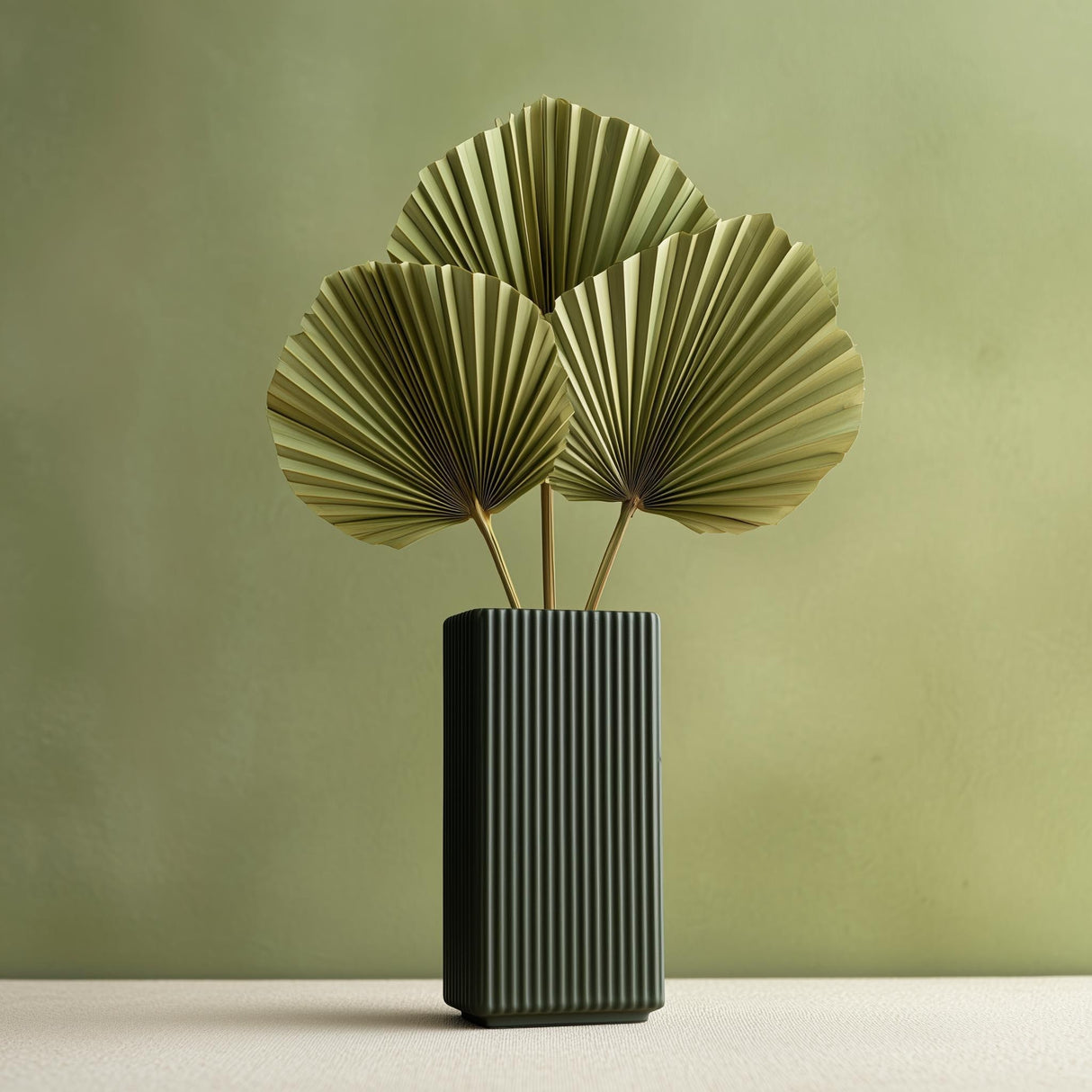 Tall rectangular 3D printed vase with vertical ribbed grooves in dark green color, shown with dried palm leaves for illustration; flowers are not included.