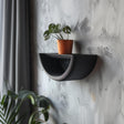 3D printed minimalist half-circle wall shelf with curved design and modern matte PLA finish, styled with a small plant