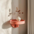 3D printed round minimalist wall shelf with vase, modern matte PLA texture, circular floating design in natural light