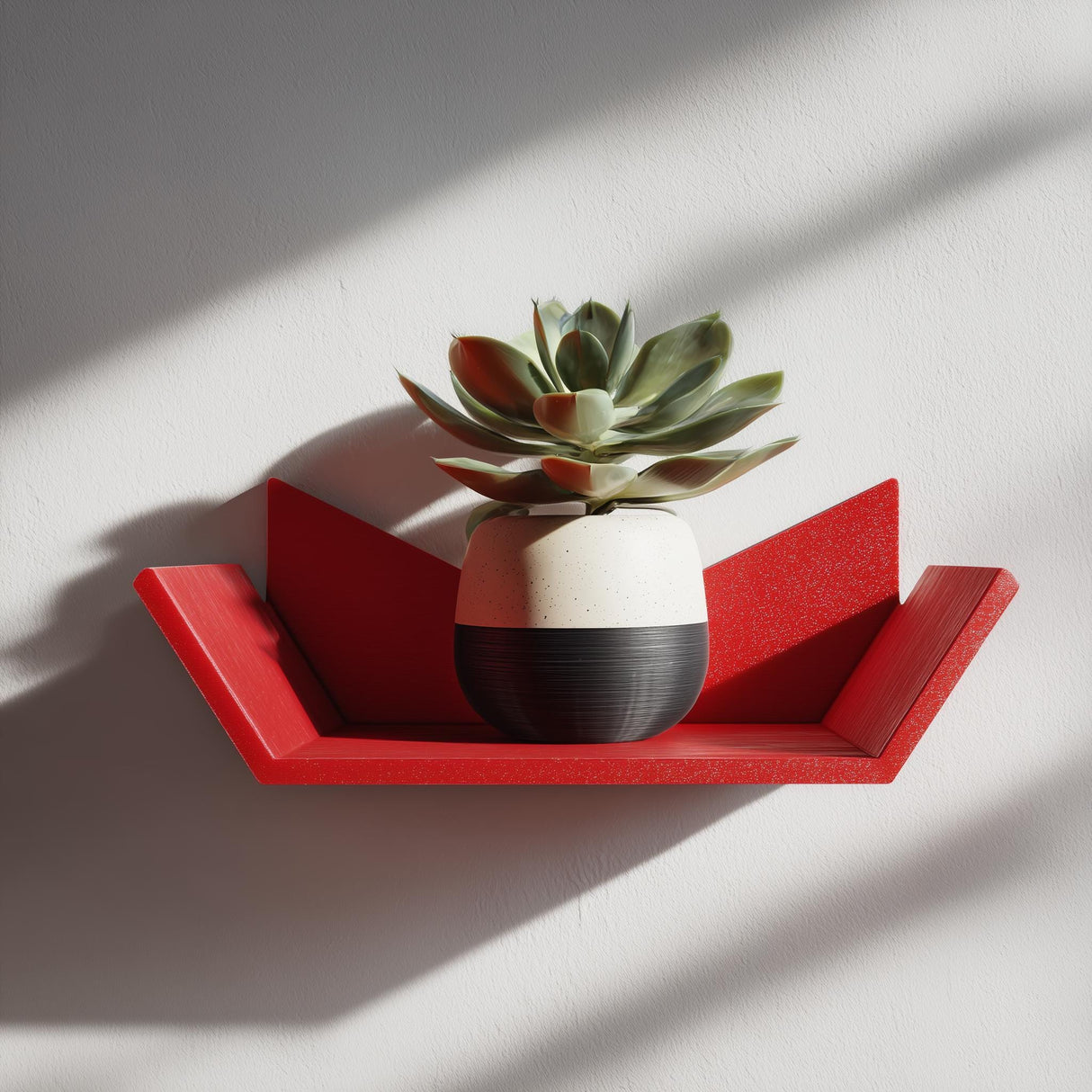 3D printed geometric wall shelf in red, holding a potted succulent, displayed as modern aesthetic wall decor