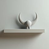 3D printed wall-mounted shelf with a small horned creature figure standing on a rectangular ledge against a light-colored wall.