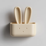 3D printed matte PLA wall-mounted bunny organizer box with tall rabbit ears and a small front pocket on a light wall.