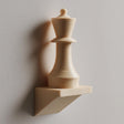 3D printed matte PLA wall-mounted chess piece with a small triangular base ledge, used as minimalist wall decor on a light wall.