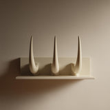 3D printed wall-mounted shelf with three tall curved horns rising from a back panel in matte PLA, styled as modern gothic wall decor.