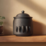 3D printed dark fantasy pet cremation urn with fang-like sculpted details, displayed as a gothic memorial decor piece on a wooden shelf.