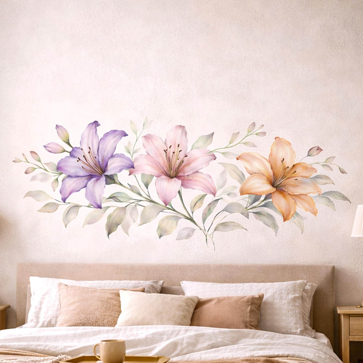 A horizontal watercolor illustration of three lilies in a row on a white background. From left to right: a light purple lily, a soft pink lily, and a warm peach lily. The flowers are connected by a central horizontal stem with delicate, pale green and grey leaves.