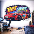 A 3D-effect illustration of a red sports car bursting through a white brick wall. The words "FAST BOOST" are written in large, colorful graffiti letters above the car. The background inside the wall crack features a dark space theme with colorful stars and paint splashes.