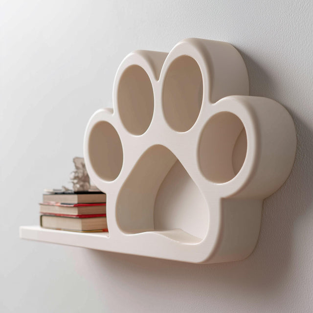3D printed paw print shaped wall shelf with integrated small display platform, mounted on a light minimalist interior wall.
