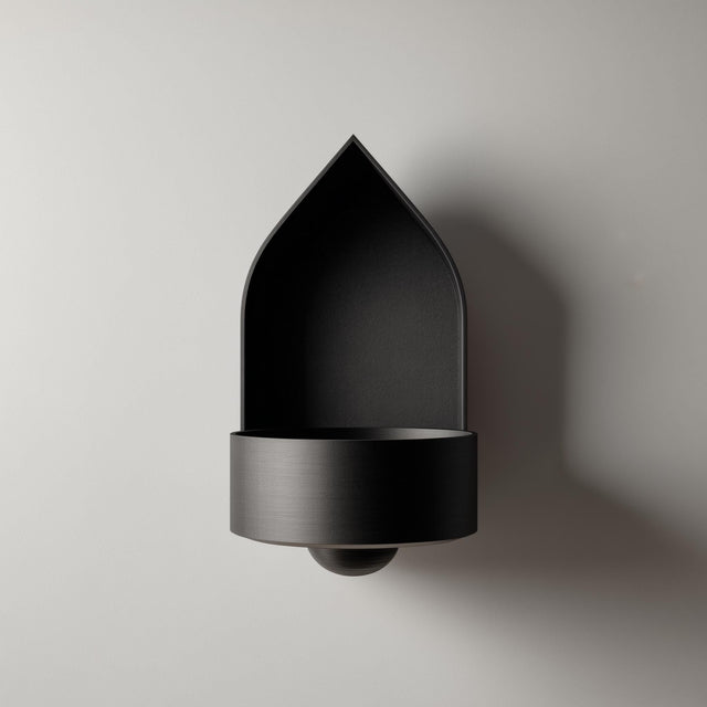 3D printed arched wall mounted shelf with a pointed backplate and a small integrated bowl tray, minimalist sculptural design on a clean wall.