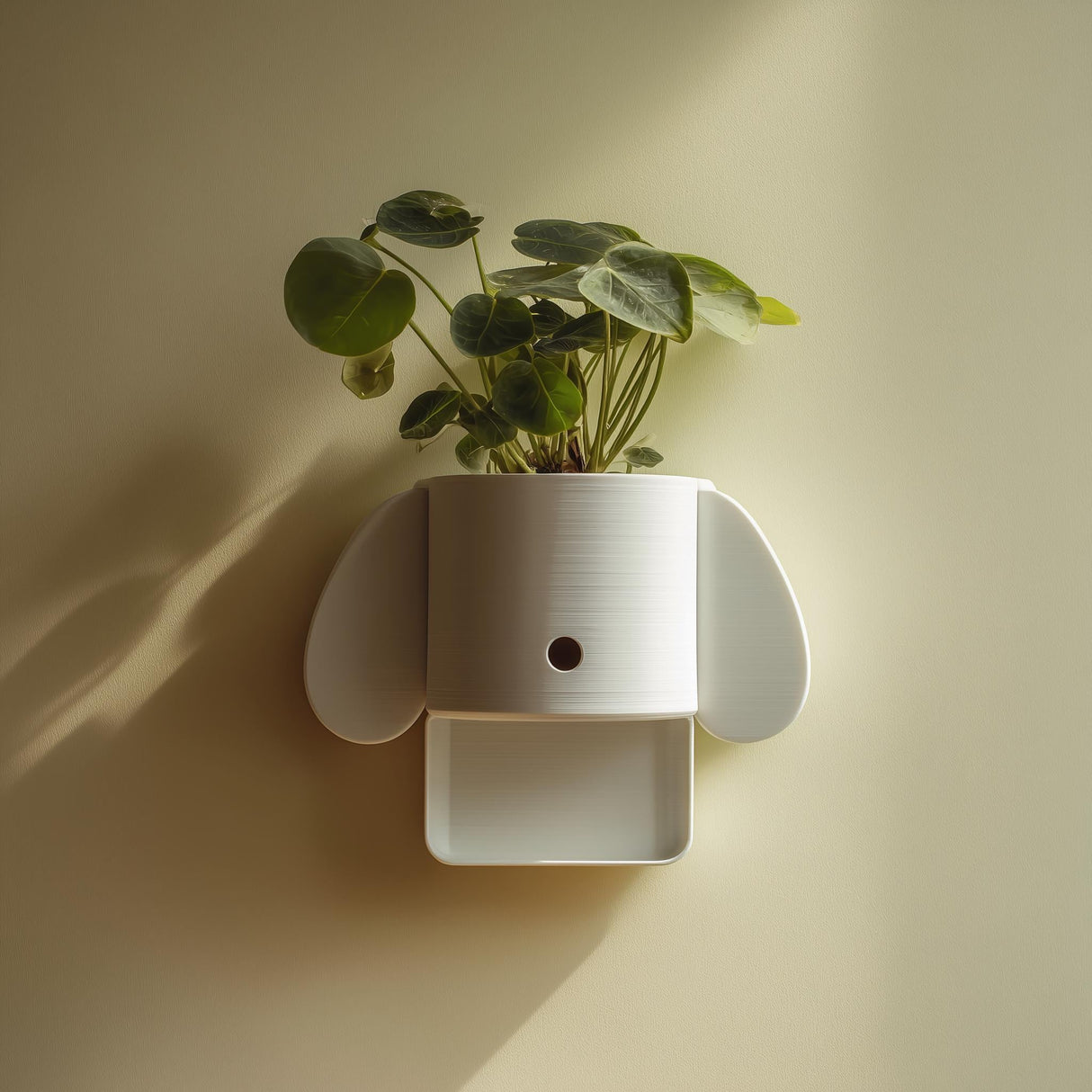 3D printed minimal dog-shaped wall planter shelf in matte white PLA mounted on a soft warm wall and holding a green houseplant.