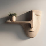 3D printed wall mounted shelf shaped like a minimalist face mask with a long nose-style floating ledge, holding a small potted plant on a plain wall.