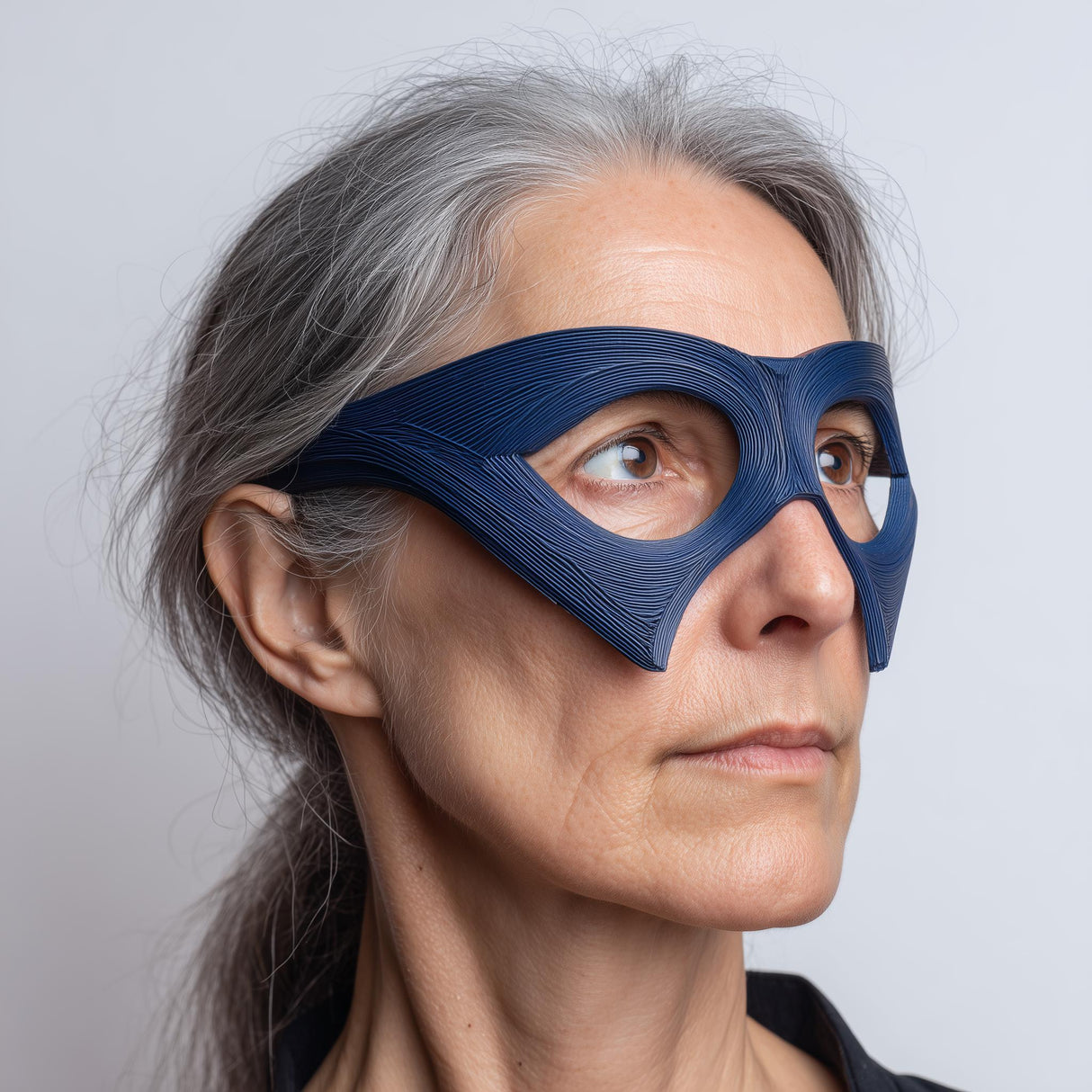 3D printed avant-garde mask glasses style eye mask with large oval eye cutouts and angular side panels, worn in a studio portrait on a neutral background.