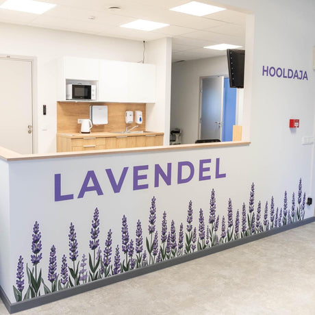 Watercolor wall vinyl decal border of tall purple lavender flowers with green stems and leaves arranged in a long meadow-style row.