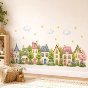 Watercolor wall vinyl decal of a cute row of pastel village houses with trees and flowers and clouds.