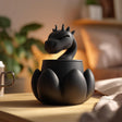 3D printed fantasy dragon memorial urn with removable lid and sculpted dragon emerging from the top, displayed on a wooden tabletop.
