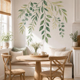 Watercolor-style cascading branches with sage, olive and pale yellow-green leaves arranged along an upper wall.