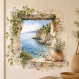 Watercolor-style stone window wall decal framing a blue sea view, with trailing vines, flowers, seashells and a terracotta pot.
