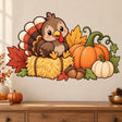Smiling brown turkey on a golden straw bale, surrounded by orange pumpkins, acorns, green vines and fall leaves.