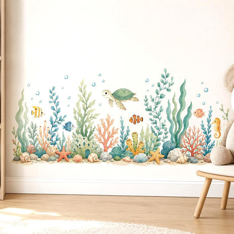Green sea turtle above watercolor-style coral and seaweed, surrounded by tropical fish, a seahorse, shells, starfish and bubbles.