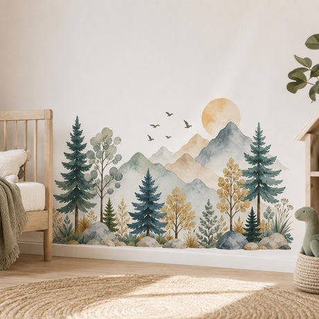 Watercolor-style mountain wall decal with blue-gray peaks, an ochre sun, teal evergreens, sage trees, birds and grasses.