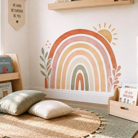 Boho rainbow in terracotta, blush, mustard and sage, with a yellow sun, leafy side branches and small decorative dots.