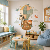 Hot air balloon nursery wall art with a patchwork balloon, small birds, pale green clouds and golden stars.