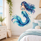 Blue and turquoise mermaid in profile with flowing hair, a scaled curved tail and pale fin highlights on a bedroom wall.