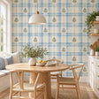 Blue botanical plaid wallpaper with watercolor checks and small olive green floral sprigs on an ivory background.