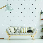 Stylish living room featuring 50x cross sticker vinyl wall decor on white walls and modern sofa with decorative pillows.