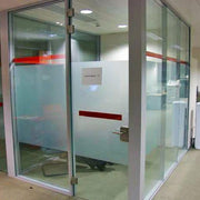 Office glass meeting room with frosted window film and red accent lines for privacy and style.