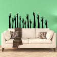 Hand silhouette vinyl decals arranged above a sofa for a seasonal wall display.