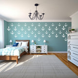 Charming bedroom with vintage anchor wall decals, creating a nautical vibe with blue walls and wooden furniture.